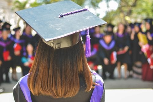 A young woman wearing a cap and gown.