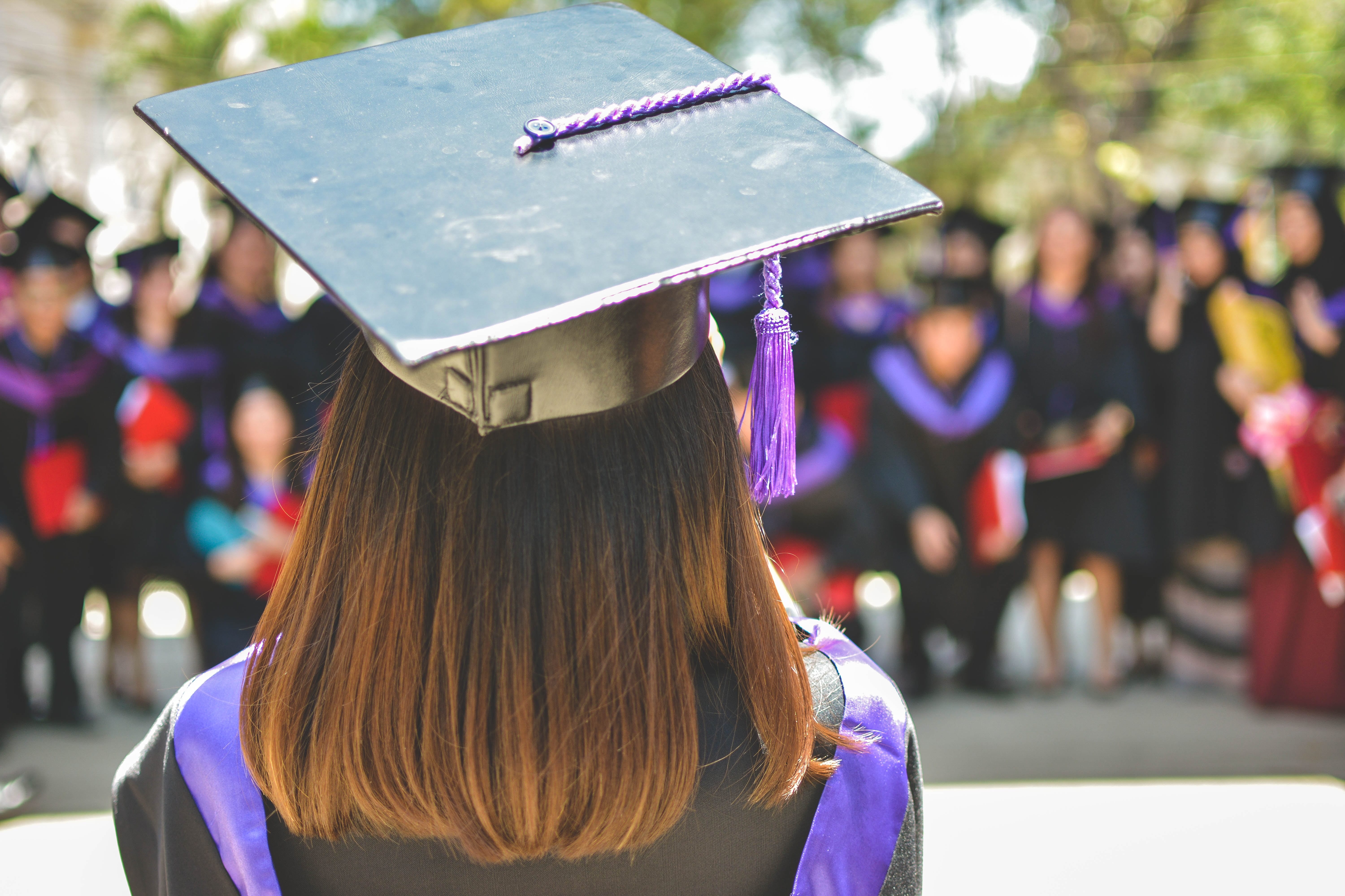 A young woman wearing a cap and gown.